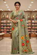 Indian fashion model wearing sage green floral embroidered silk saree, front view